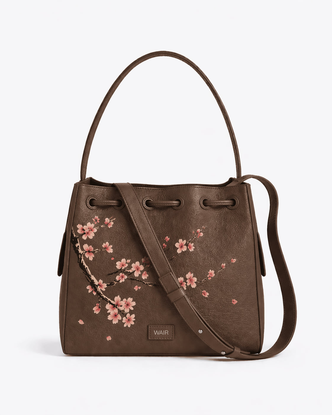 The Cove in espresso leather with a hand-painted pink blossom commission across the front.